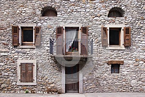 Beige stone wall with many windows