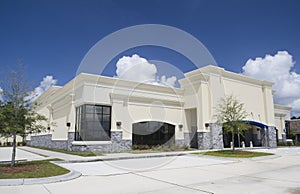 Beige stucco with gray brick retail store