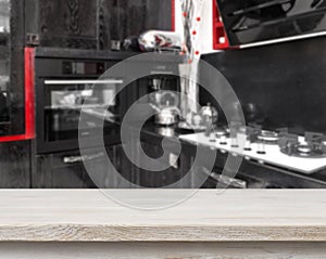 Beige table on defocused black kitchen background