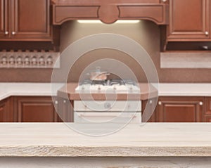 Beige table on defocused kitchen stove interior background