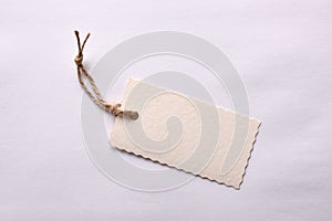 Beige textured paper tag tied with string