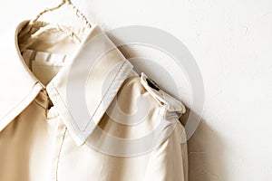 A beige trench coat isolated over white