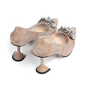 Beige velvet women& x27;s heeled shoes with beige insole decorated with crystals on the front on a white background