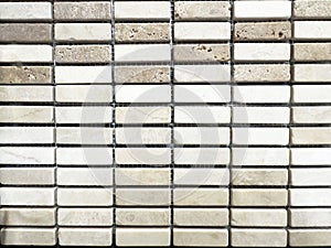 Beige and white textured stone tile wall background