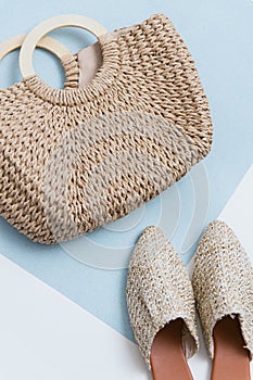 Beige wicker bag and mules on a pastel background. Wicker basket and shoes top view. trendy and stylish accessories. Trend 2019