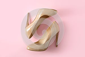 Beige women high heel shoes on pink background. Fashion blog look. Top view, flat lay.