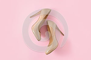 Beige women high heel shoes on pink background. Fashion blog look. Top view, flat lay.