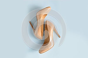Beige women high heel shoes on pink background. Fashion blog look. Top view. View from above.