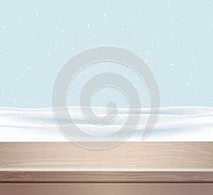 Beige wood table top panel on winter blurred abstract background wih snow.