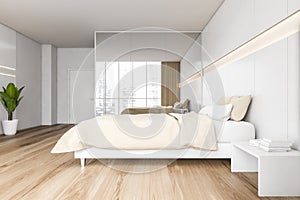 Beige wooden bedroom with bed and linens, wardrobe and parquet floor