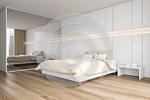 Beige wooden bedroom with bed and linens, wardrobe on parquet floor