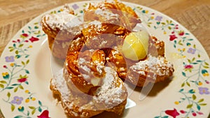 Beignet with cream and decorated with icing sugar