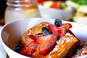 Beignet with fruit and blueberries for breakfast