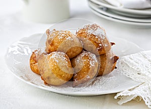 Beignets covered with powdered sugar.