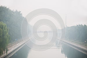Beijing air pollution seen from a bridge overlooking a canal