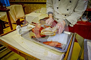 BEIJING, CHINA - 29 JANUARY, 2017: Professional chef cutting a famous traditional peking duck using knife, delicious