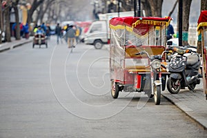 BEIJING, CHINA - MARCH 12, 2016: Tourists in a rickshaw in a hut