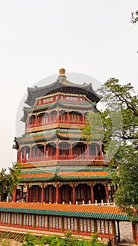 Beijing - A colorful five storied pagoda in the park complex of Summer Palace in Beijing, China. There is a small fence