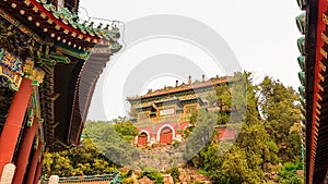 Beijing - A panoramic view on a buildings complex in park of Summer Palace in Beijing, China. The buildings are richly decorated