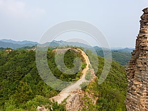 Beijing - A panoramic view on an unrenewed Gubeikou part of Great Wall of China. The wall is spreading on tops of mountains