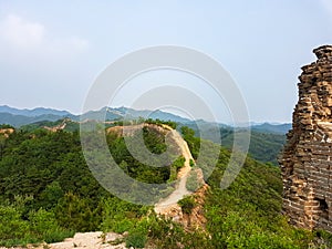 Beijing - A panoramic view on an unrenewed Gubeikou part of Great Wall of China. The wall is spreading on tops of mountains