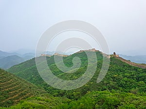 Beijing - A panoramic view on an unrenewed Gubeikou part of Great Wall of China. The wall is spreading on tops of mountains