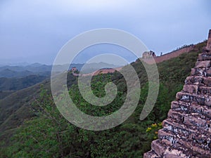 Beijing - A panoramic view on an unrenewed Gubeikou part of Great Wall of China. The wall is spreading on tops of mountains