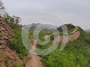 Beijing - A panoramic view on an unrenewed Gubeikou part of Great Wall of China. The wall is spreading on tops of mountains