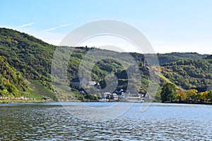 Beilstein, Germany - 10 06 2022: Mosel with Beilstein and a ship in autumn