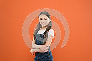 Being great every day. Fashion baby girl. Cute little fashion model on orange background. Small child with fashion look