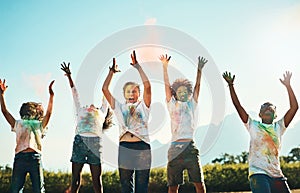 Being a kid is all about having fun. a group of teenagers having fun with colourful powder at summer camp.