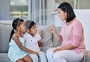 Being a parent can be frustrating. a woman scolding her two daughters.