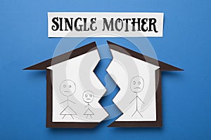 Being single mother after divorce concept. Paper cutouts demonstrating broken family on blue background, flat lay