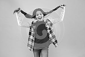 Being such a good girl. Pigtailed little girl pink background. Happy girl hold long hair. Small girl smile in casual