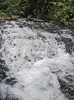 Bekasi, Indonesia, foam from the swift current of water in a river. photo