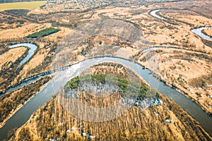 Belarus. Aerial View Of Dry Grass And Curved River Landscape In Early Spring Day. High Attitude View. Marsh Bog. Drone