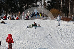 Parents and children ride from the snow slides in winter have fun resting in nature.