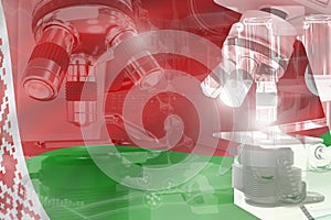 Belarus science development conceptual background - microscope on flag. Research in nanotechnology or chemistry, 3D illustration