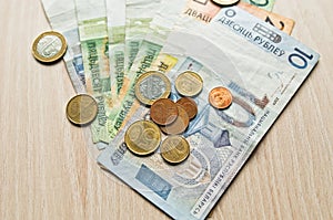 Belarusian rubles and coins on a colored background photo