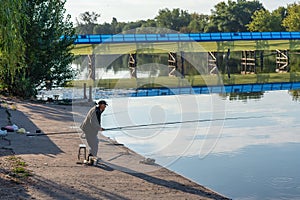 Belaya Tserkov, Ukraine, August 24, 2020: Elderly man fishing on the bank of the river