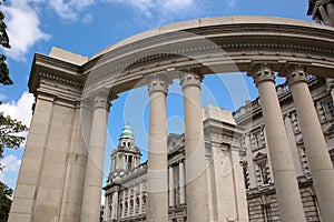 Belfast City Hall building with a classical Renaissance stone exterior and corner tower with columns.  Belfast, Northern Ireland.