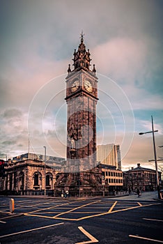 BELFAST, NORTHERN IRELAND, DECEMBER 19, 2018: People passing by Queen's Square where Albert Memorial Clock Tower is situated.