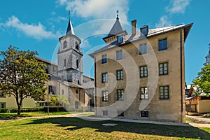 Belfry of the cathedral and the parish under blue sky in Chambery, France