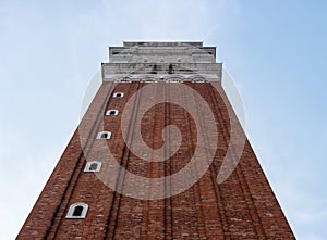 Belfry of St. Mark`s Basilica in Venice, Italy.Campanile di San Marco in Italian. Photographed from below along the wall