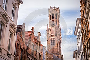 Belfry tower and flemish architecture in Bruges at sunny day, Belgium