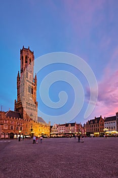 Belfry tower and Grote markt square in Bruges, Belgium on dusk in twilight