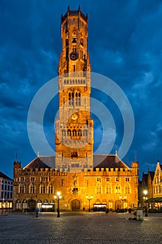 Belfry tower and Grote markt square in Bruges, Belgium on dusk in twilight