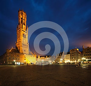 Belfry tower and Grote markt square in Bruges, Belgium on dusk in twilight