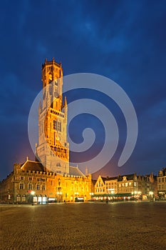 Belfry tower and Grote markt square in Bruges, Belgium on dusk in twilight