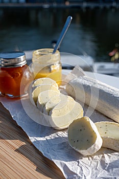 Belgian abbey cheese fagotin in pieces with jam served outdoor, Wallonia, Belgium